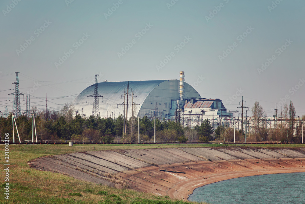 nuclear reactors of Chernobyl power plant next to Pripyat river, 4th (exploded) reactor with sarcophagus on left, 3th reactor on right, Exclusion zone, Ukraine