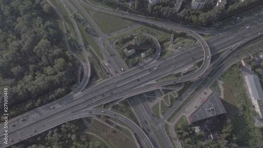 Aerial view of the network of overpasses, junctions, intersections, roads, bridges on the outskirts of Warsaw. Filmed from 4K drone in RAW. Video for post-processing. Aerial view of the network of overpasses, junctions, intersections, roads, bridges on the outskirts of Warsaw. Filmed from 4K drone in RAW. Video for post-processing.