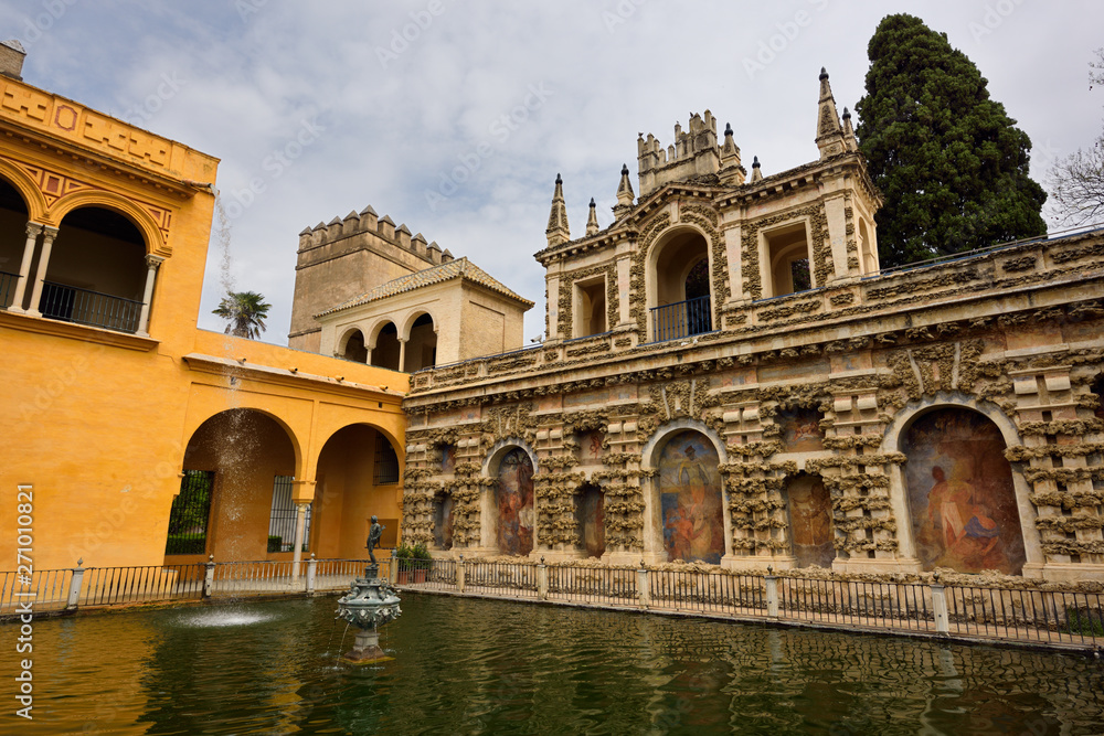 Gothic palace and Mercury pond with fountain at Royal Alcazar of Seville Andelusia Spain