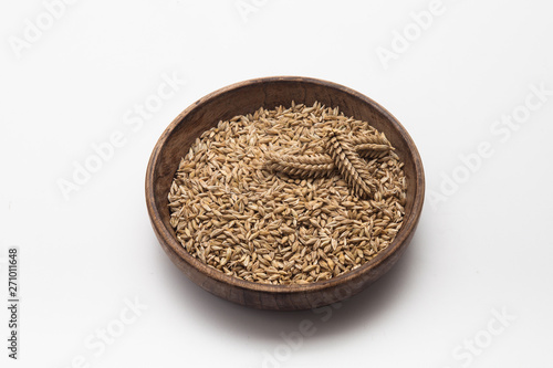  Barley grains with wheat ear on plate isolated 