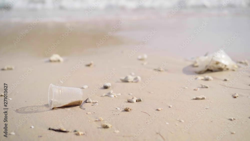 plastic trash with wave breaking on beach, waste pollution concept plastic trash with wave breaking on beach, waste pollution concept