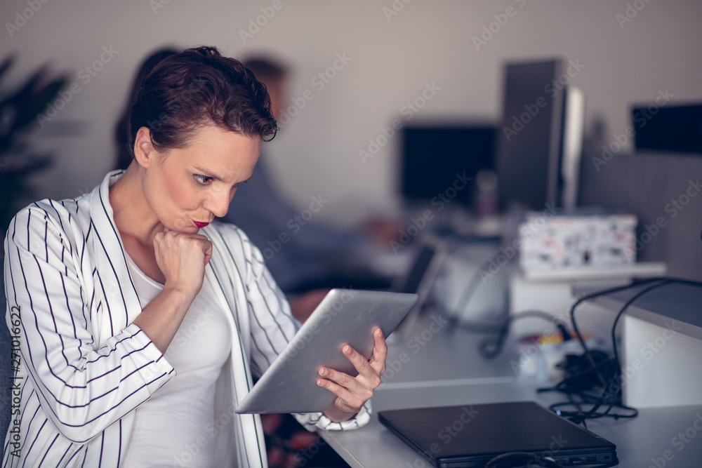 Stylish brunette working from home in her home office Stylish brunette working from home in her home office