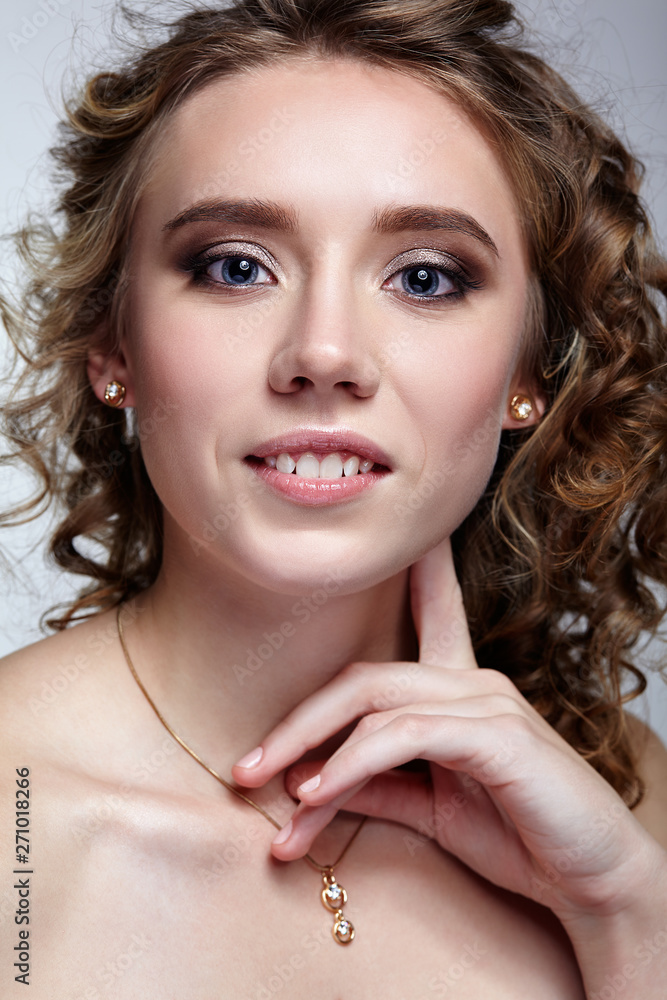 Beauty portrait of young woman with hands near face