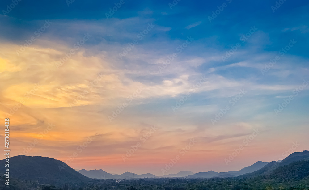 Landscape of mountain range with beautiful sunset sky. Mountain with fog in the evening. Colorful sky and clouds at sunset. Mountain valley in Thailand. Scenery of mountain layer at dusk.