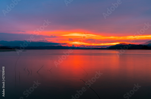 Red and orange sunset sky at the mountain and lake. Beautiful evening sky. Majestic sunset sky. Nature background.