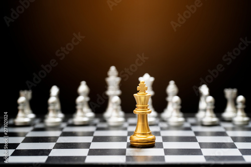King chess game on chessboard with black background. Business and teamwork concept