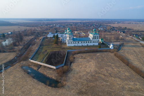 View of the ancient Nikolo-Vyazhishsky monastery on April evening (aerial photography). Vyazhishchi, Novgorod region. Russia photo