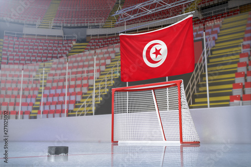 Flag of Tunisia in hockey arena with puck and net