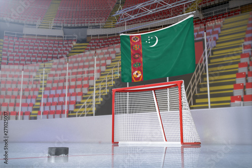 Flag of Turkmenistan in hockey arena with puck and net