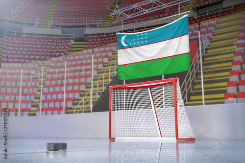 Flag of Uzbekistan in hockey arena with puck and net