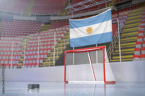 Flag of Argentina in hockey arena with puck and net