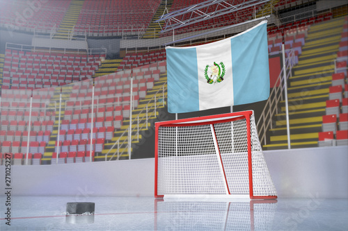 Flag of Guatemala in hockey arena with puck and net