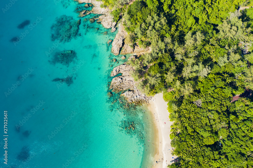 View from above, stunning aerial view of a tropical coast with a white beach bathed by a turquoise clear sea. Phuket, Thailand. View from above, stunning aerial view of a tropical coast with a white beach bathed by a turquoise clear sea. Phuket, Thailand.