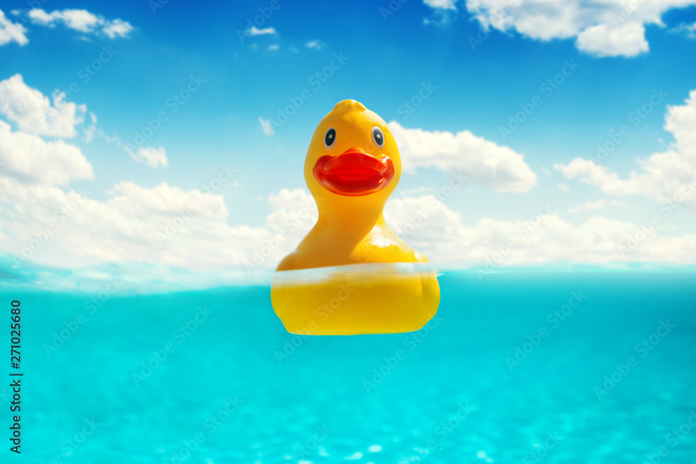 Rubber duckling floating in water. Summer vacation. Rubber duckling floating in water. Summer vacation.