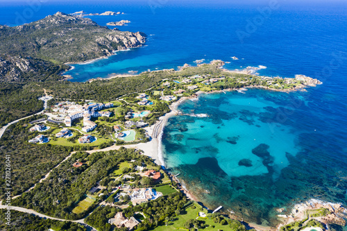 View from above, stunning aerial view of the Romazzino Beach bathed by a beautiful turquoise sea. Costa Smeralda (Emerald Coast) Sardinia, Italy.