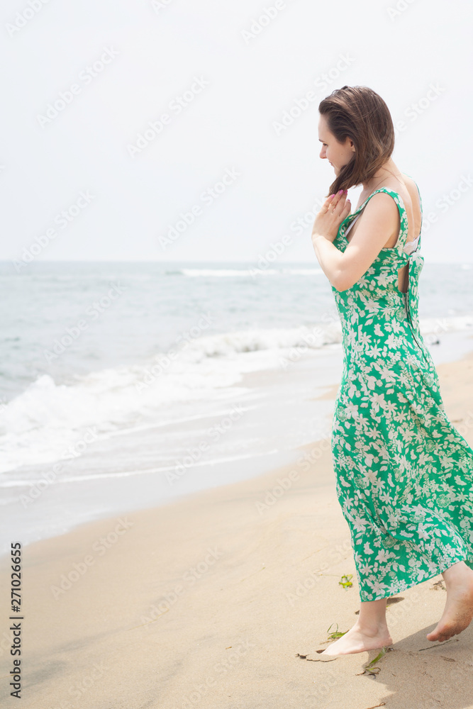 young thoughtful girl walks along the beach on a sunny day young thoughtful girl walks along the beach on a sunny day