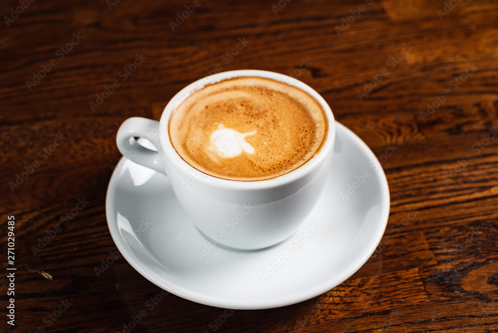 cup of cappuccino on the wooden background cup of cappuccino on the wooden background