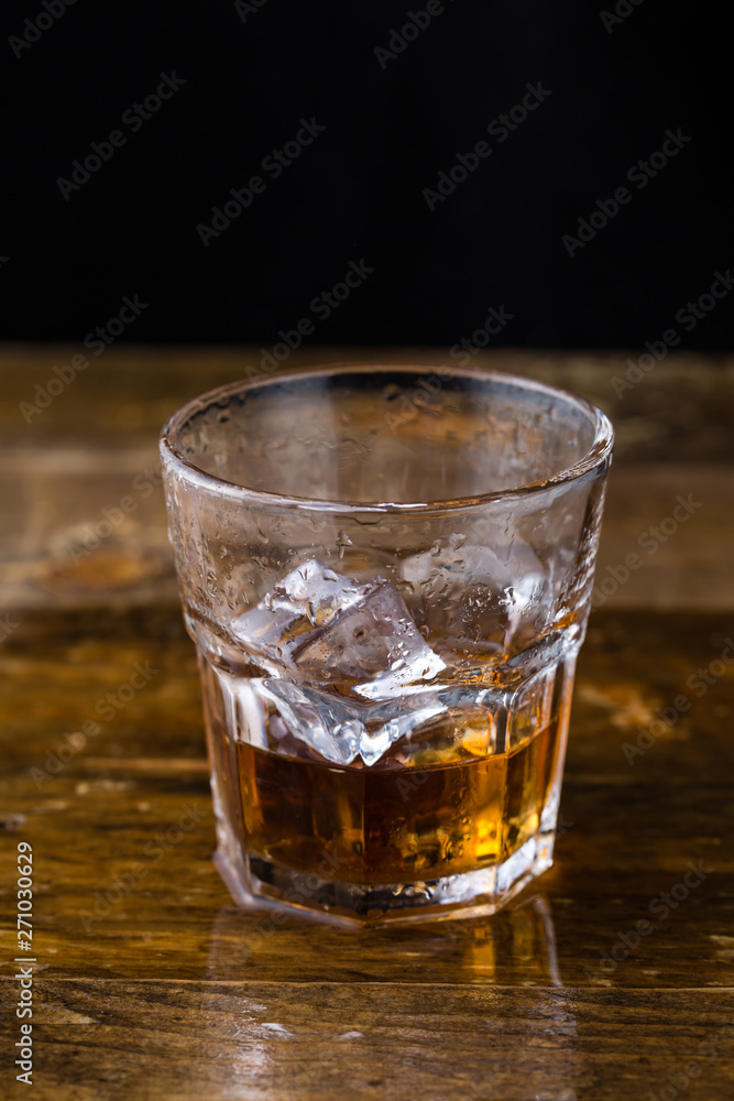 Glass of whiskey on wooden background, close up Glass of whiskey on wooden background, close up