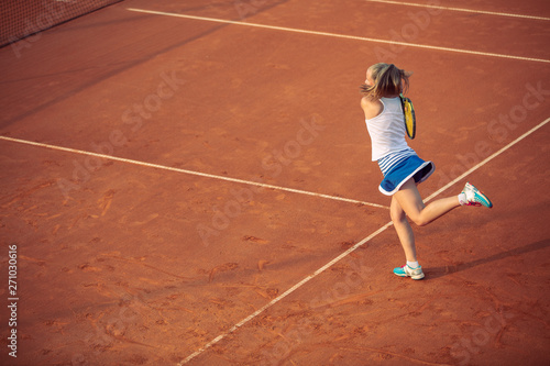 Woman playing tennis on clay court, with sporty outfit and healthy lifestyle