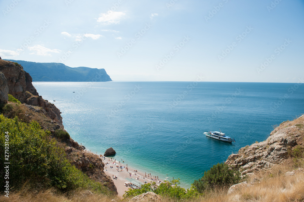 beautiful scenery of summer blue sea gulf with ship and tourist people on beach during leisure vacation