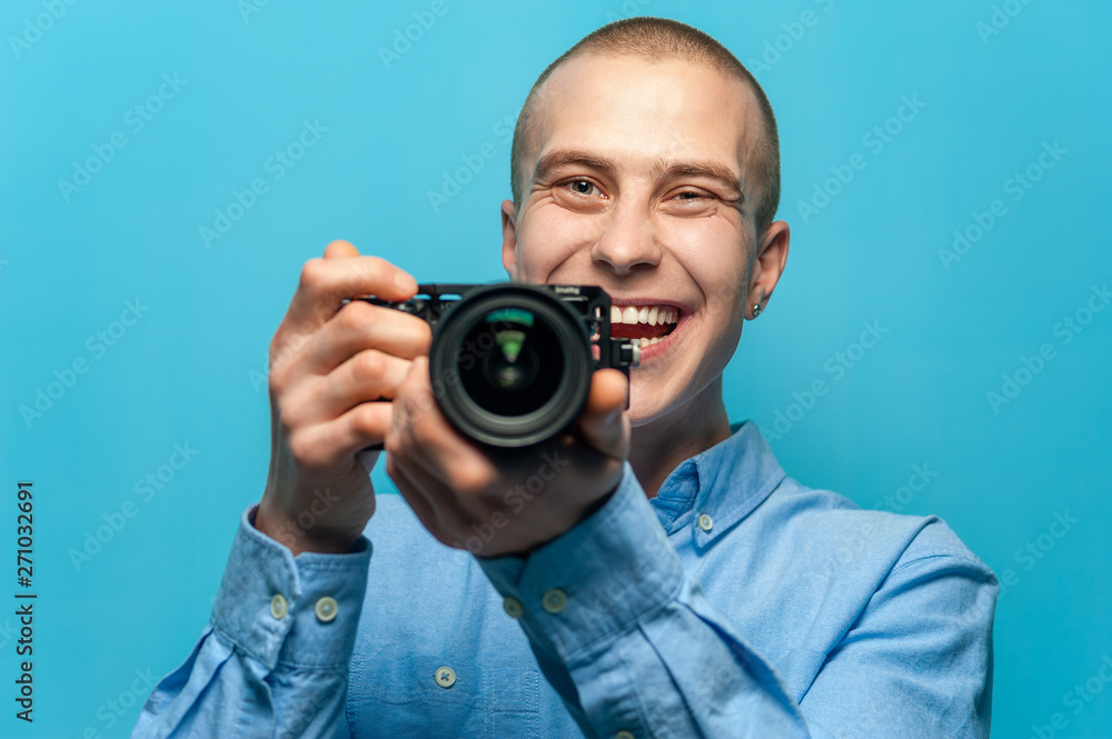 Positive man in stylish clothes photographer holds camera