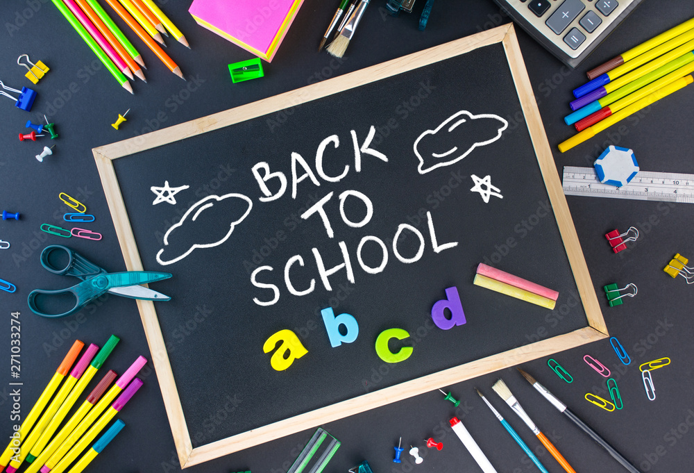Back to School concept school and office supplies on a black background all stationery items with black board Back to School concept school and office supplies on a black background all stationery items with black board