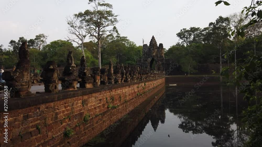 stone figures of “giants” of asuras (evil spirits) and devas (good spirits) along a dam crossing the moat at the south gate of Angkor Thom, among the complex of temples of Angkor stone figures of “giants” of asuras (evil spirits) and devas (good spirits) along a dam crossing the moat at the south gate of Angkor Thom, among the complex of temples of Angkor