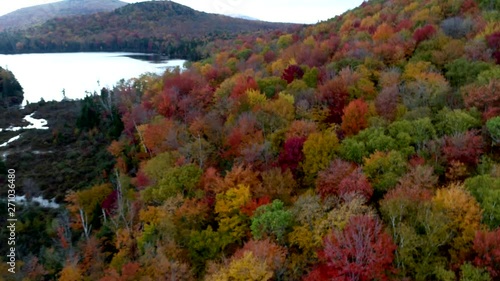 Aerial Drone - Decend From High Altitude Over Lake And Hill Showing Peak Colors in Fall in Vermont photo