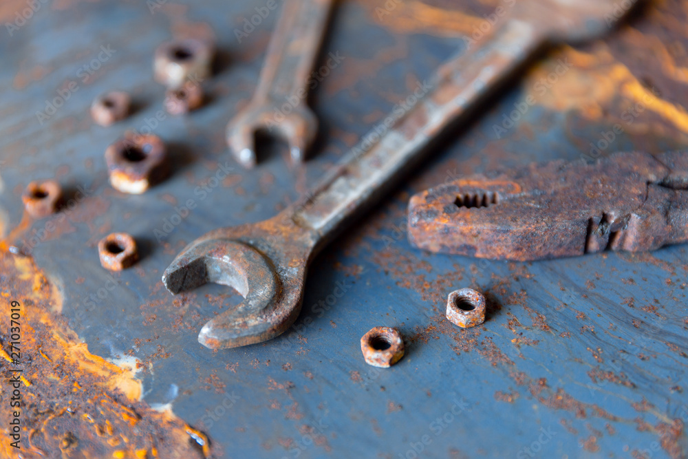 Old rusty wrench over battered metal table rough style. Wrenches top view for construction, industrial, electrician concept design Old rusty wrench over battered metal table rough style. Wrenches top view for construction, industrial, electrician concept design