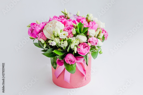 Wallpaper Mural Arrangement of flowers in a hat box. Bouquet of peonies, eustoma, spray rose in a pink box with an oasis on a white background Torontodigital.ca