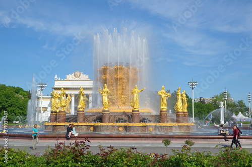 Moscow, Russia - may 20, 2019: Fountain "Friendship of peoples" on the background of the pavilion "Russian Soviet Federal Socialist Republic" at VDNH