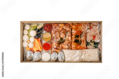 Collection of take away kraft boxes with different bbq food. Set of containers with everyday meals - meat, vegetables and law fat snacks on white background, top view. 