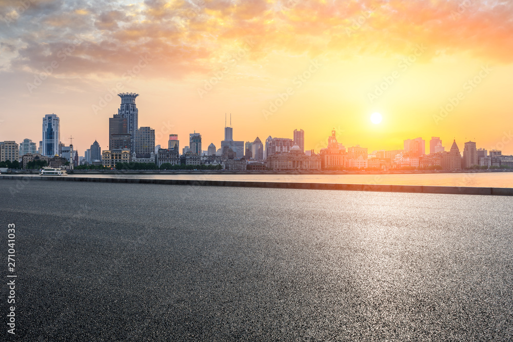 Fototapeta premium Shanghai bund city skyline and empty asphalt highway at sunset