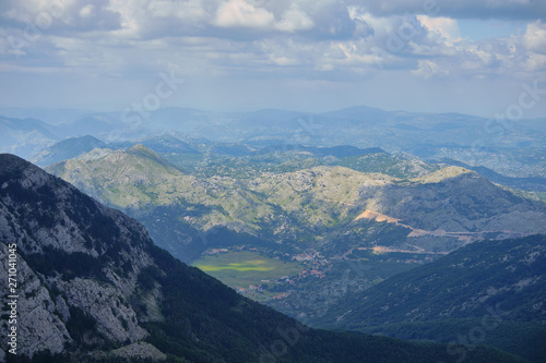 View from the mountain peak Lovchen on a sunny day. Blue sky with clouds, a bird's eye view. © StockAleksey