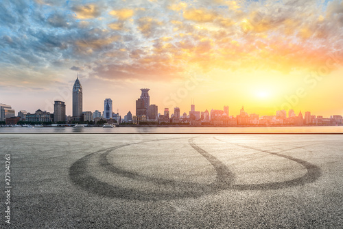 Shanghai bund city skyline and empty asphalt road ground at sunset