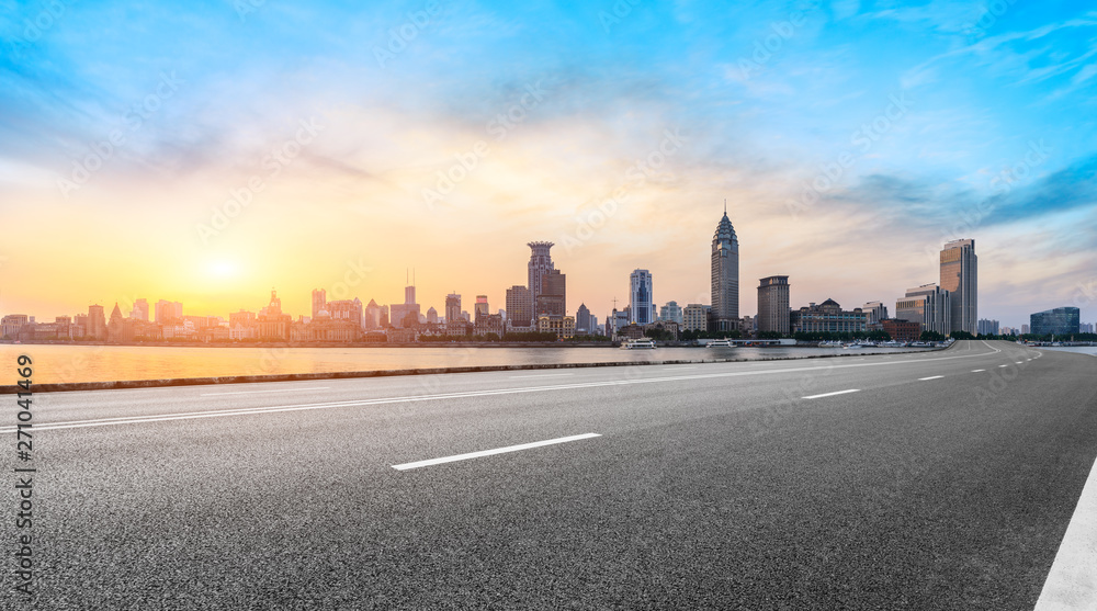 Shanghai bund city skyline and empty asphalt highway at sunset Shanghai bund city skyline and empty asphalt highway at sunset