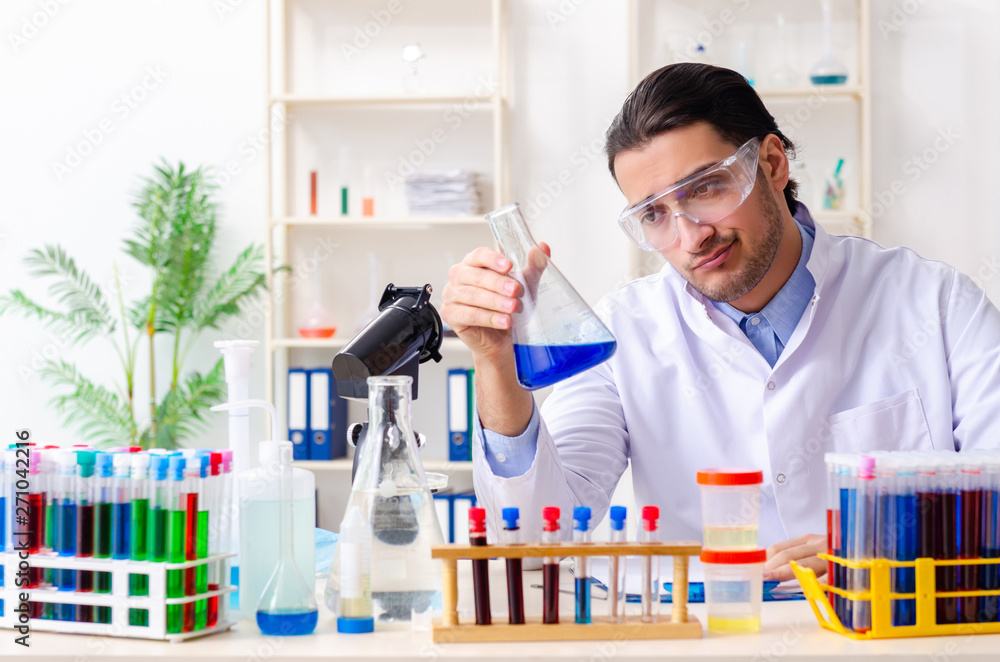 Young male chemist working in the lab Young male chemist working in the lab