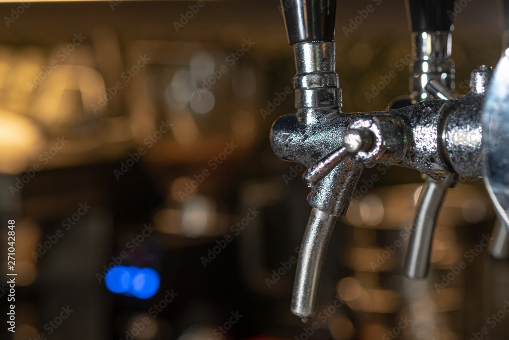 Pub Interior With Taps of Draft Beer. Taps of draft beer inside a sports bar Pub Interior With Taps of Draft Beer. Taps of draft beer inside a sports bar