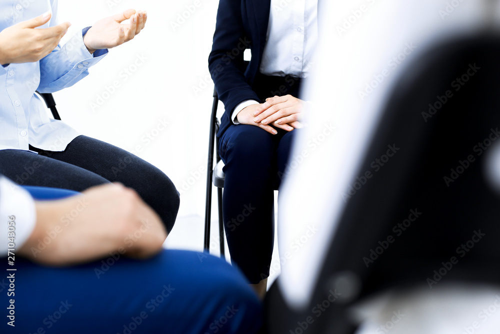Group of people sitting in a circle during therapy. Meeting of business team participating in training Group of people sitting in a circle during therapy. Meeting of business team participating in training