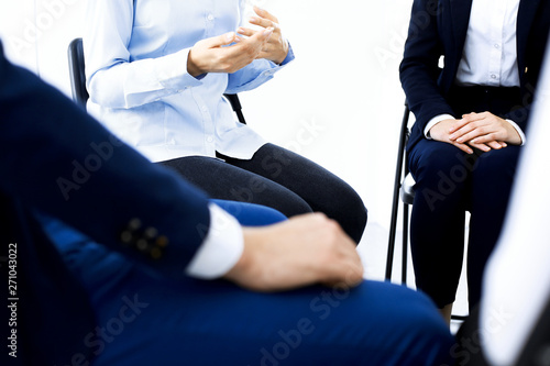 Group of people sitting in a circle during therapy. Meeting of business team participating in training