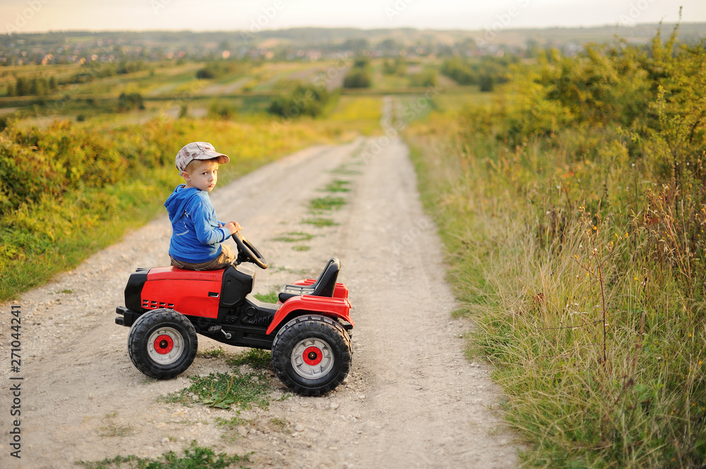 Child with a toy tractor on a trip. Child with a toy tractor on a trip.