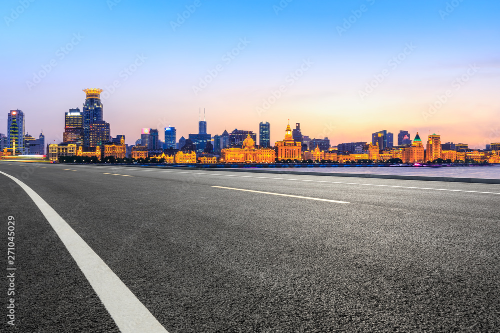 Shanghai city skyline and empty asphalt highway at sunset Shanghai city skyline and empty asphalt highway at sunset