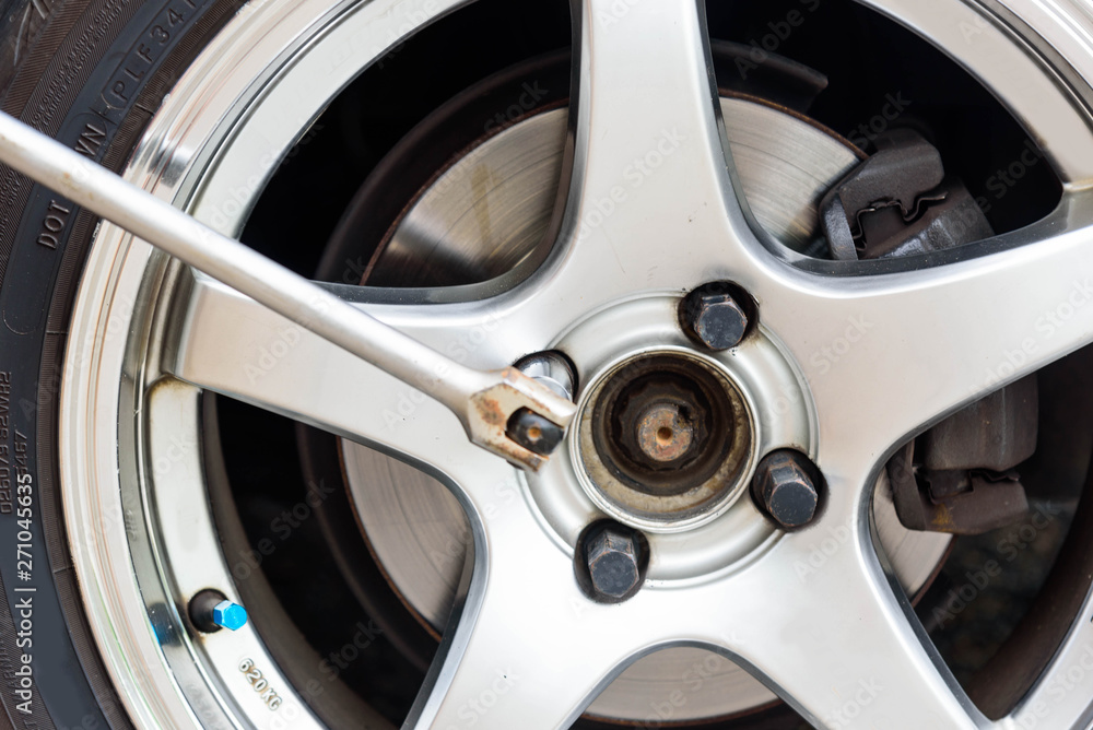 change the wheel of car / Turn the nut for unlock the car wheel change the wheel of car / Turn the nut for unlock the car wheel