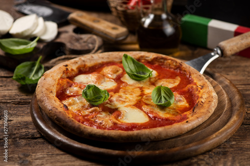 Italian pizza Margherita on a wooden table