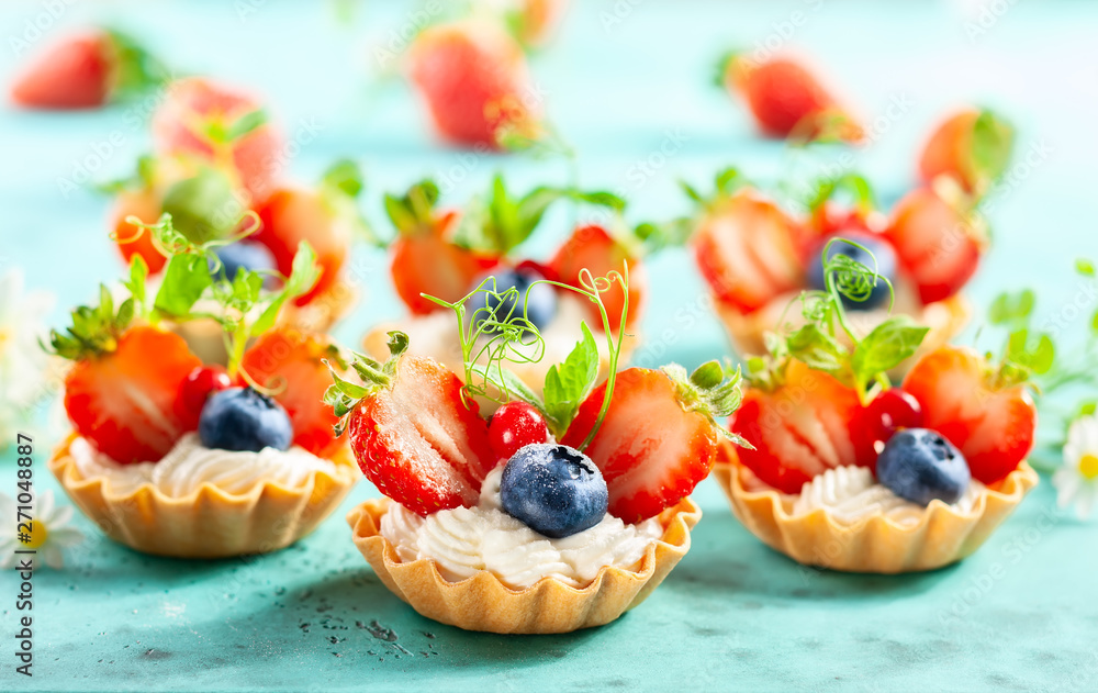 Summer berry tartlets with cream and fresh berries. Summer berry tartlets with cream and fresh berries.