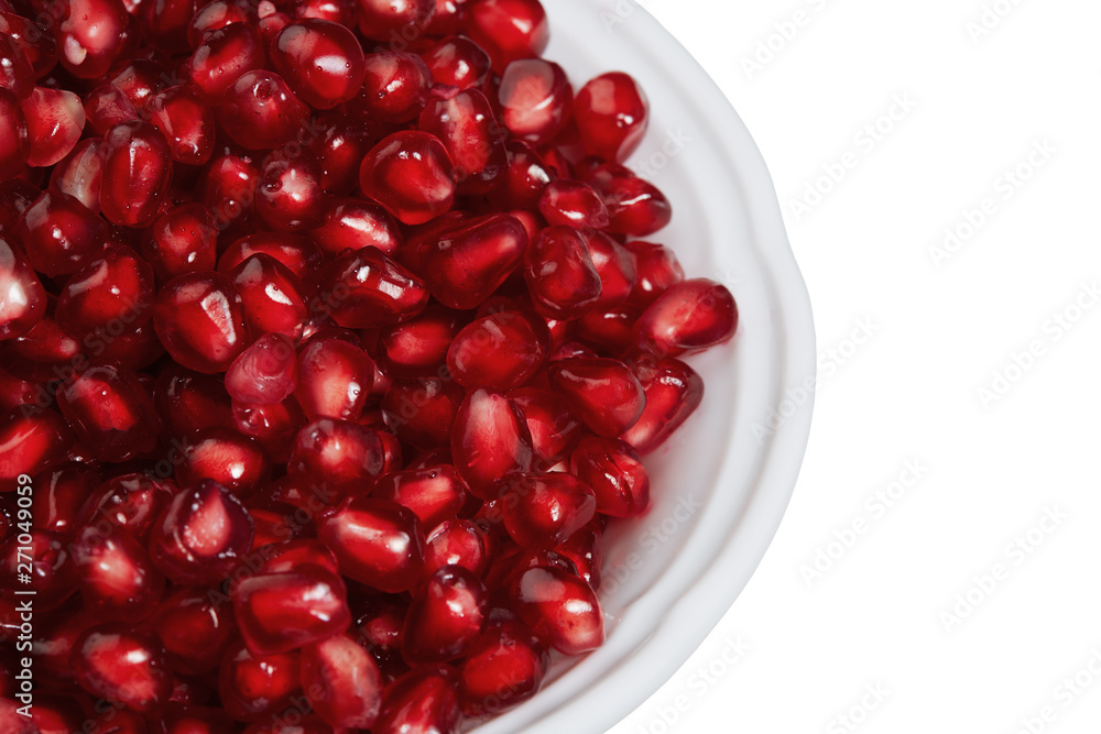 Pomegranate seeds in a bowl isolated on white background. Top view, close-up Pomegranate seeds in a bowl isolated on white background. Top view, close-up