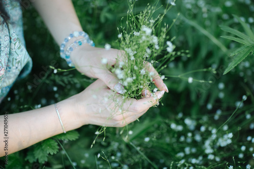 herb girl with a bouquet of wildflowers, closeup