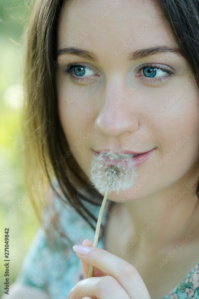 woman playing with a dandelion, lips and dandelion women large, close-up woman playing with a dandelion, lips and dandelion women large, close-up