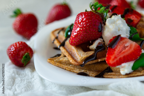 Belgium waffles dessert with strawberries, ricotta cheese and chocolate. Selective focus.