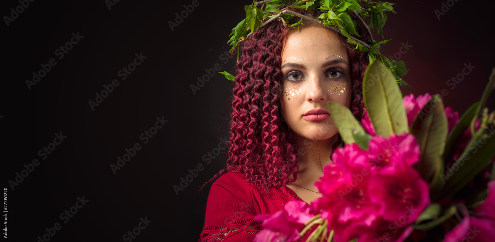 Portrait of attractive young woman in red dress with bouquet of red rhododendron and wreath on a head. Portrait of attractive young woman in red dress with bouquet of red rhododendron and wreath on a head.